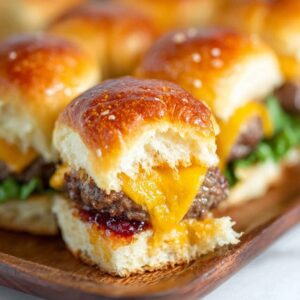 Easy cheeseburger sliders on Hawaiian rolls with melted cheese and sesame seeds
