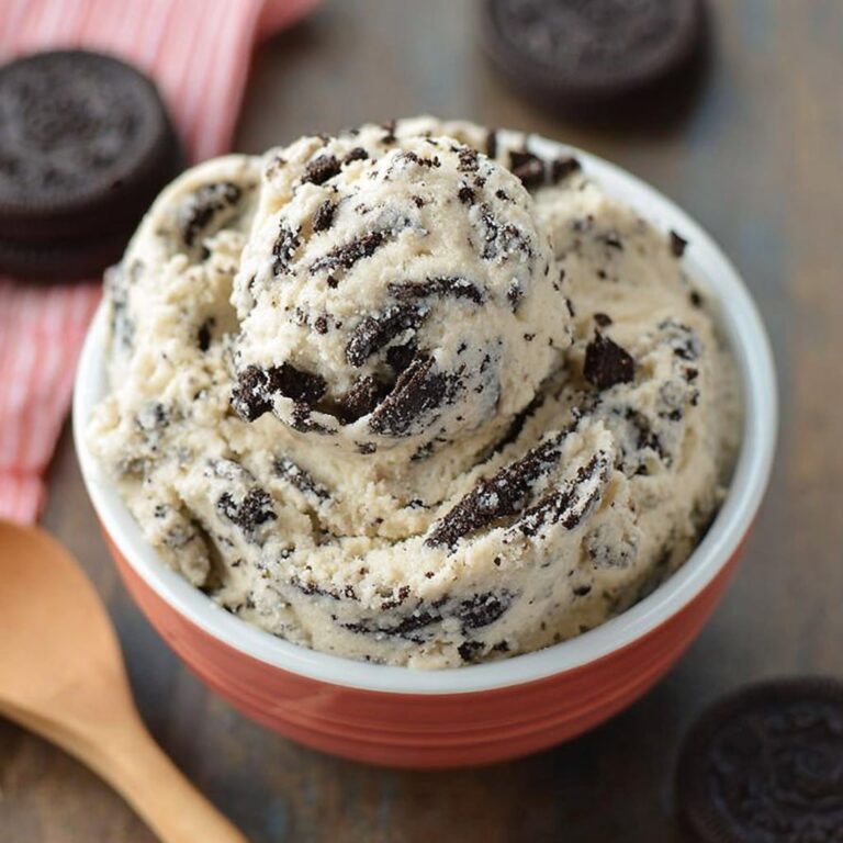 Edible Oreo cookie dough in a bowl topped with crushed Oreos and chocolate chips