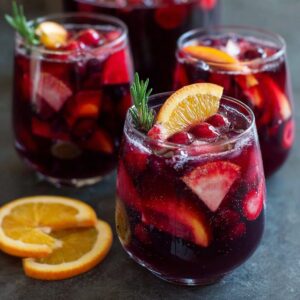 A large pitcher of big-batch Costco budget sangria filled with red wine, fruit slices and ice