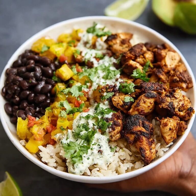 Cuban chicken and black bean rice bowl with cilantro lime rice, mojo-marinated chicken, plantains, and fresh cilantro