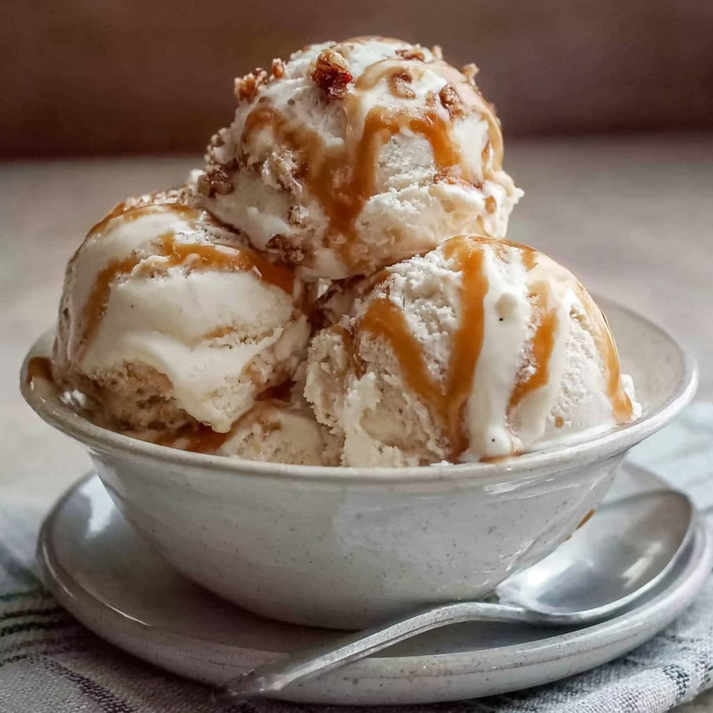 Close-up of cottage cheese ice cream scoop showing creamy texture, caramel ribbons, and sprinkled flaky salt