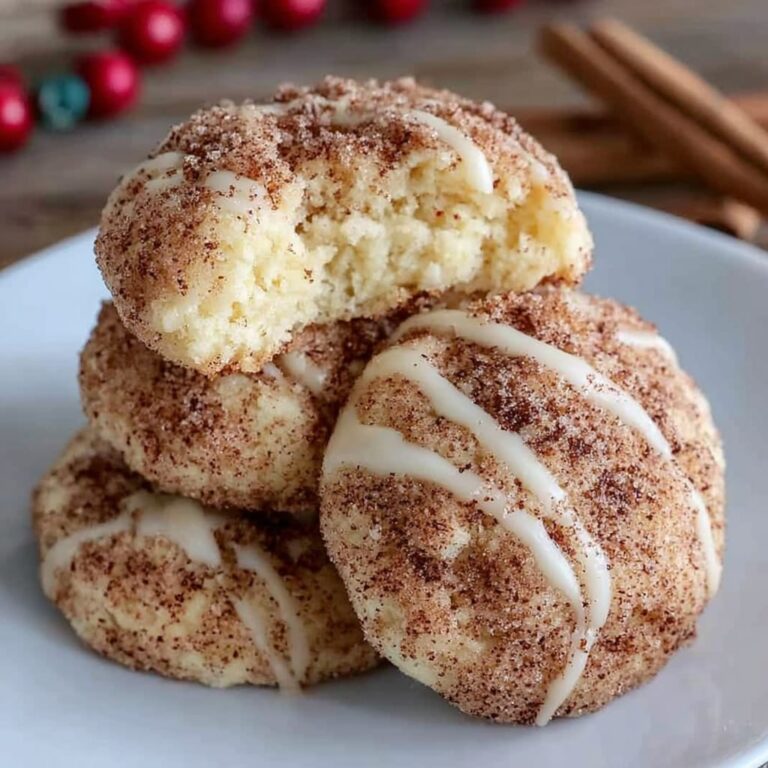 Soft cinnamon sugar cream cheese cookies stacked on a marble surface, crackled cinnamon-sugar tops, pillowy soft centers visible in a broken cookie, warm afternoon light